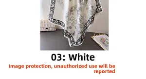 Detail of white silk scarf featuring black floral butterfly prints and baroque scroll edges