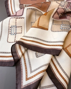Detailed view of silk-like scarf with earth-tone patterns and elegant draped texture