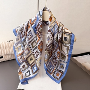 Elegant geometric print silk-like square scarf styled on a mannequin neck for a chic look