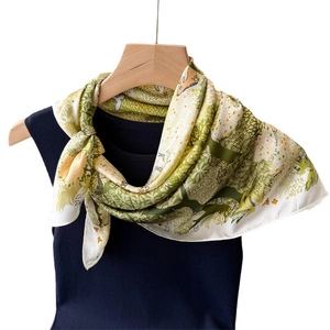 Elegant forest animal print faux silk scarf displayed on a hanger with blue vest