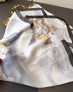 Detail of silk satin scarf featuring ink wash bird and plum blossom pattern on vintage tray