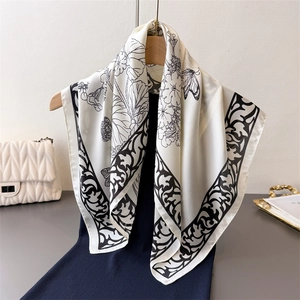 Elegant silk scarf with ink landscape flower prints draped over a black dress