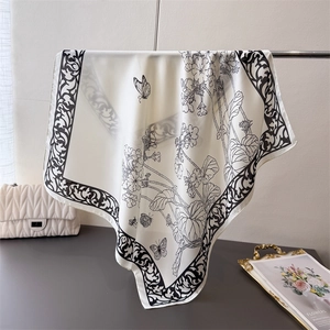 Satin silk scarf featuring black line art floral patterns and butterfly prints