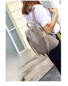 Side view of taupe waterproof nylon backpack showing side pockets and fabric straps