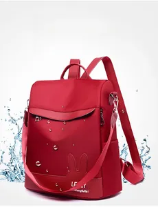 Detailed view of red waterproof oxford fabric backpack with rabbit ear design