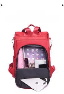 Interior view of red nylon backpack showing large capacity for tablet and daily items