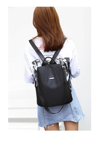 Rear view of a black oxford backpack showing waterproof fabric and side pockets for travel