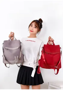 Nylon backpack with cute rabbit ears and brand logo in mauve and red colors