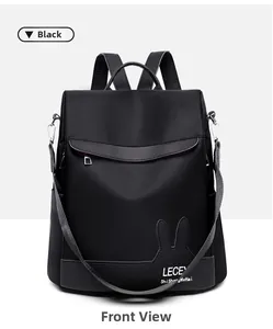 Detail of black nylon backpack with leather rabbit ear accent and metal buckles