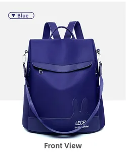 Detailed close-up of blue nylon backpack featuring cute rabbit ear leather accents