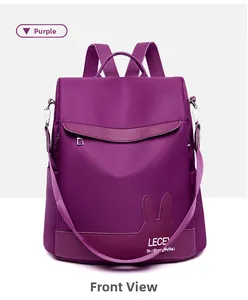 Front view of purple nylon backpack featuring cute rabbit ear leather trim and brand logo