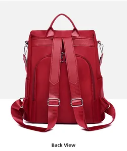 Back view of deep red nylon backpack featuring adjustable straps and hidden security zipper