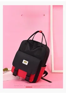 Detail of multi-pocket backpack with red contrast bottom and buckled front flap