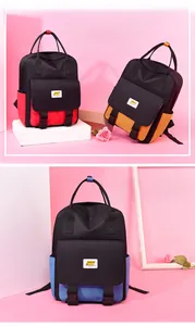 Detail of color-block nylon backpack featuring dual buckle front pocket and GNEI logo