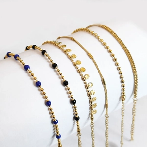 Detail of six assorted 18K gold plated stainless steel bracelets and anklets set