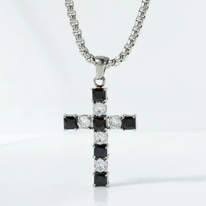 Macro shot of cross pendant with alternating black square gems and round cubic zirconia