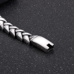 Macro shot of silver wheat link chain texture and plug-in clasp for men's bracelet