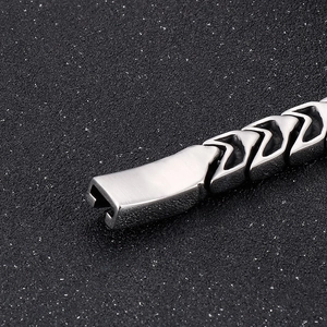 Detailed close-up of V-shaped stainless steel link bracelet with brushed metal texture