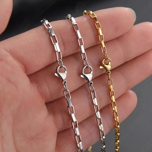 Detail of minimalist 304 stainless steel box chains in silver and gold with lobster clasp