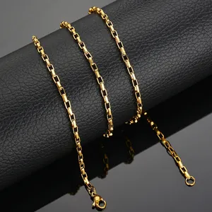 Macro shot of polished gold-finished stainless steel box chain with lobster clasp detail
