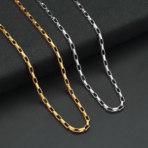 Polished silver and gold box chains for men and women on a minimalist black background