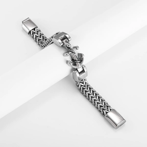 Macro detail of men's stainless steel anchor bracelet with textured nautical chain link