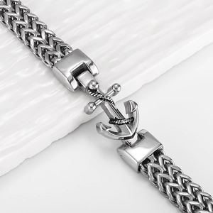 Macro shot of silver wheat chain bracelet with a detailed nautical anchor clasp