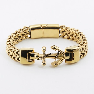 Detail of gold anchor bracelet with thick wheat chain link and polished metal finish