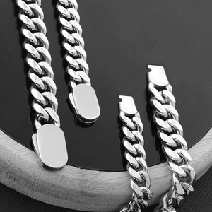 Macro detail of polished stainless steel Cuban link chain with push-pull spring clasp