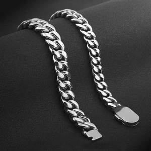 Detailed view of polished silver cuban link bracelet with sleek rectangular clasp closure