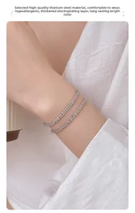 Close-up of double-layered silver titanium steel bracelet on wrist with thick plating