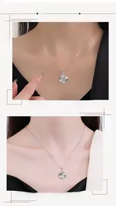 Détail du collier argenté avec fleur à cinq pétales et pendentif rond texturé serti de zircon