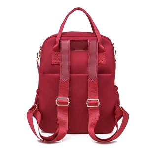 Deep wine red oxford cloth backpack with wide shoulder straps and side pockets on white background
