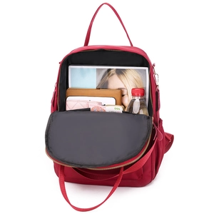 Deep red oxford backpack for women showing spacious interior with books and wallet