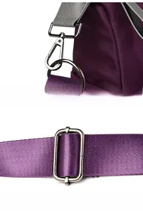 Detail of adjustable purple nylon shoulder strap with polished silver metal hooks and D-ring