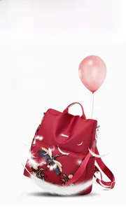 Detail of lightweight red backpack with dragonfly embroidery and 0.41KG weight indicator