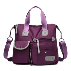Multi-pocket purple nylon shoulder bag with adjustable strap and dual handles