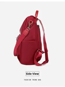 Side view of dark red waterproof Oxford cloth backpack with silver metal hooks and sturdy straps