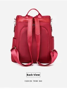 Back view of red oxford backpack showing adjustable straps and anti-theft zipper pocket