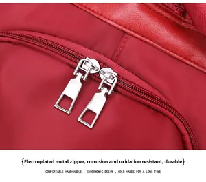 Detail of durable red waterproof oxford fabric with dual anti-oxidation metal zippers
