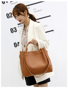 Brown large capacity tote bag with smooth synthetic leather texture and dual handles