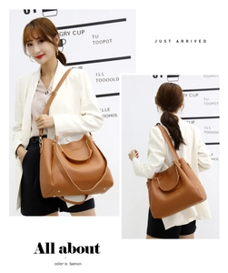 Detail of camel brown tote bag with pebble leather texture and adjustable shoulder strap