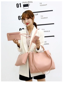 Detailed view of pink 4-piece handbag set including tote and crossbody bag with gold hardware