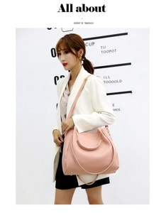 Chic pink trapezoid handbag with metal circular handle and adjustable shoulder strap
