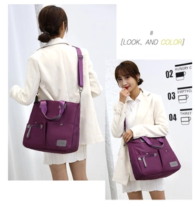 Detail view of purple nylon tote bag showing adjustable straps and multiple utility pockets