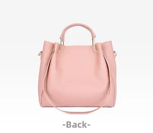 Rear view of a pink leather tote bag with gold metal handles and adjustable long strap