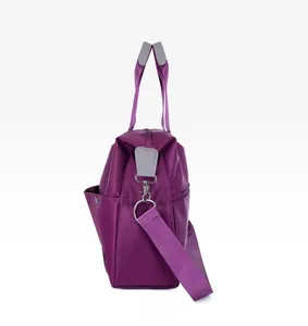 Side view of purple nylon tote with metal snaps and reinforced gray handles