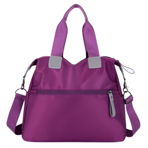 Large purple nylon tote bag with multi-pocket design and adjustable shoulder strap