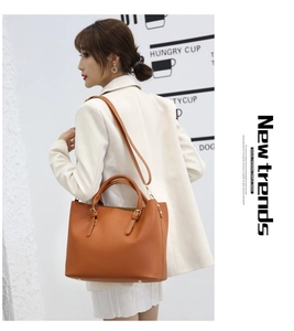 Brown-orange tote bag with detachable shoulder strap and gold hardware shown on model