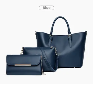 Three-piece set of blue tote bags, shoulder bag, and clutch with gold hardware detail